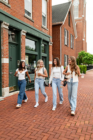 Girls walking next to the building.